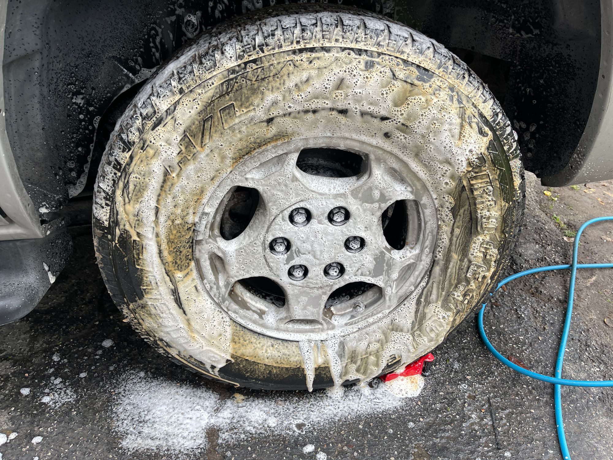 A wheel being cleaned by hand with soap suds